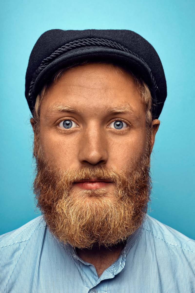 one person, portrait, front view, blue eye, male, caucasian, sailor, men, real people, indoors, studio shot, accidentally wes anderson, turquoise colored