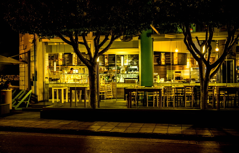 shadow, building, city life, building exterior, downtown, no people, railing, dark, windows, tree, family, street, business, chairs, outdoors, built structure