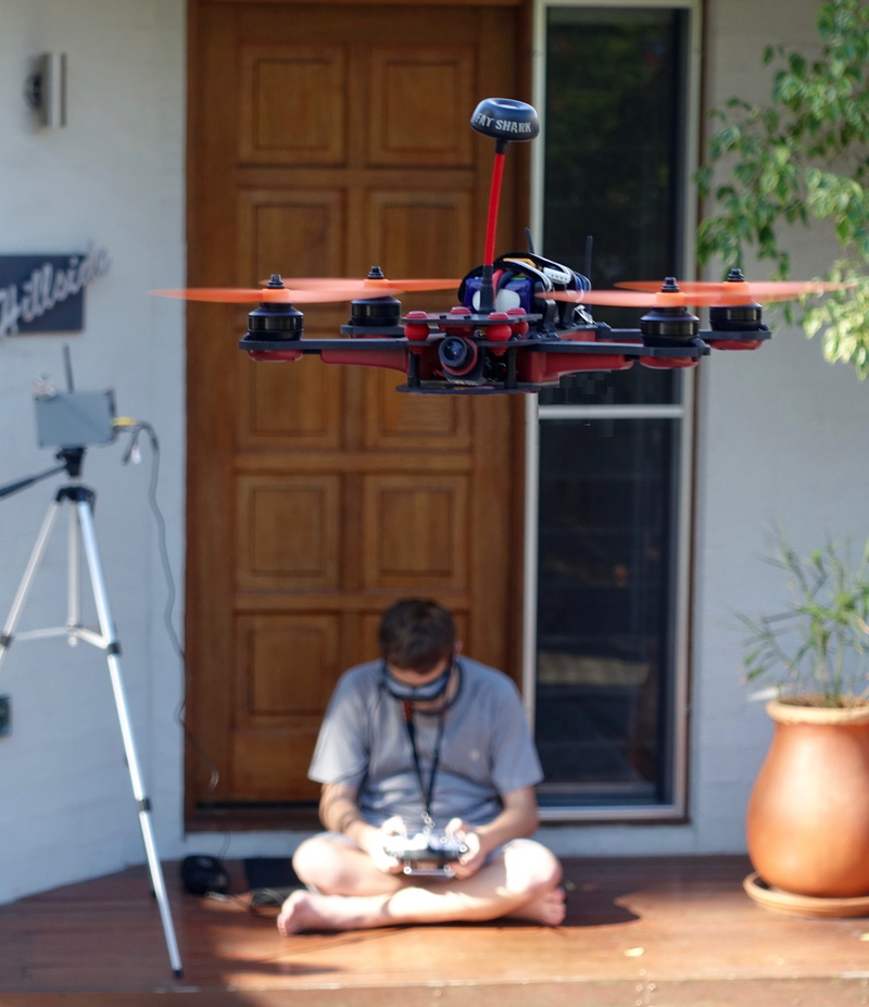 2K, one person, adult, first person view, technology, real people, quadrocopter, lighting equipment, remote, floor, sitting, stability, leisure activity