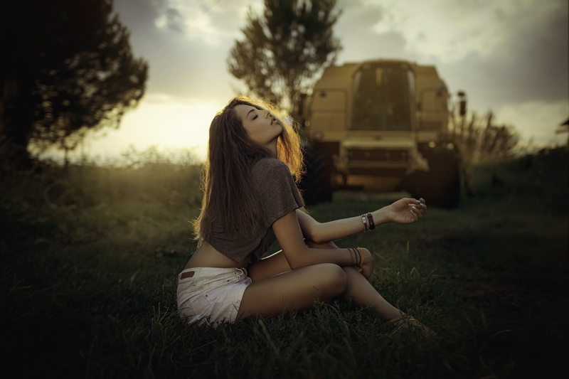 Manthos Tsakiridis, closed eyes, T-shirt, sunset, women, 1080P, women outdoors, sunlight, sitting, jean shorts, portrait