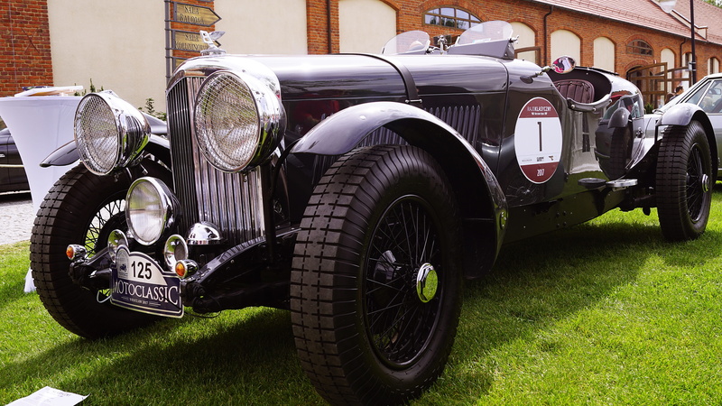 car headlights, mode of transportation, architecture, sports, vintage car, reflector, tire, building exterior, nature, land vehicle, wheels, convertible