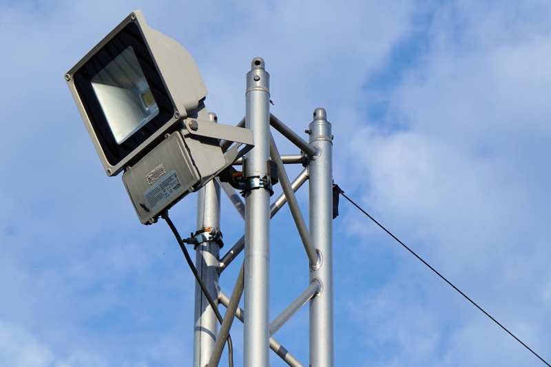 spotlight, outdoors, lighting equipment, safety, no people, sky, low angle view, security camera, halogen spotlights, electrical equipment, night, silver colored