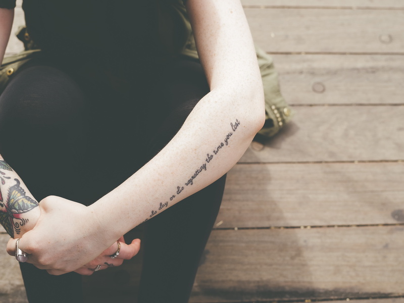 body part, wood - material, pants, ink, leisure activity, holding, midsection, forearm, lifestyles, outdoors, standing, human hand, focus on foreground