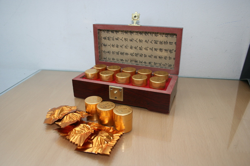 western script, number, food and drink, food, text, flooring, hardwood floor, gold Colored, container, wood, still life, fruit, pills, cordyceps, snack