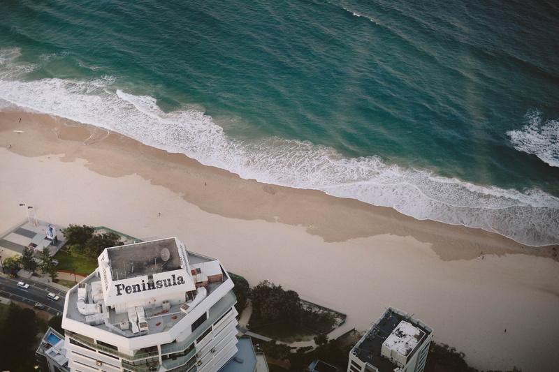 gold coast, ocean liner, wave, surfers paradise, sand, watercraft, aquatic sport, transportation, office building, outdoors, urban, land, near, motion