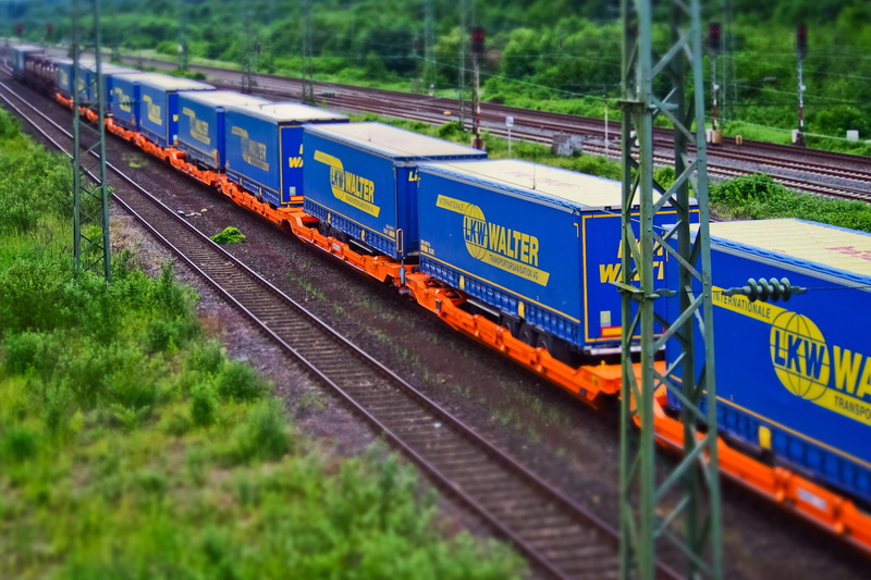 motion, transport, rail traffic, green color, outdoors, train tracks, traffic, arrival, plant, railway, no people, goods wagons, public transportation