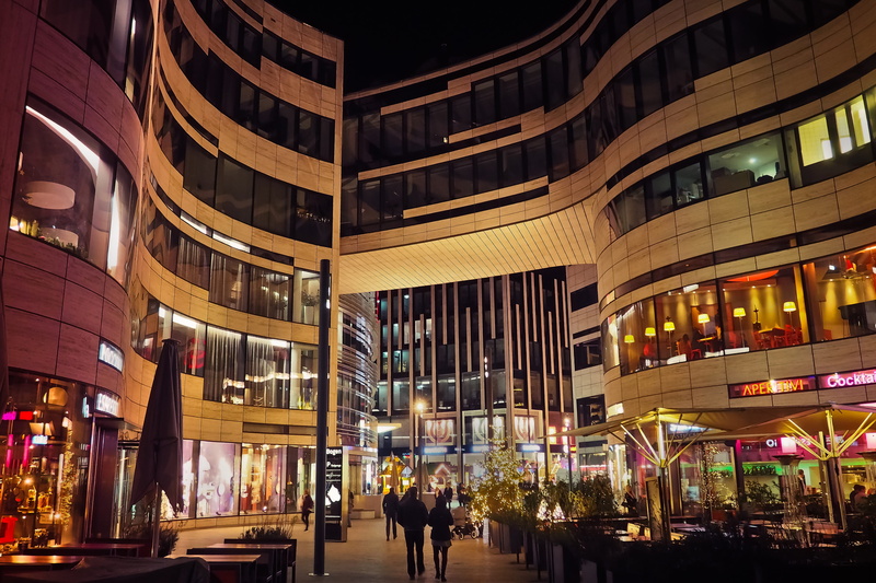 city life, reflection, real people, illuminated, incidental people, city, women, walking, nightlife, building, kö bow, urban, sky, night, adult, modern