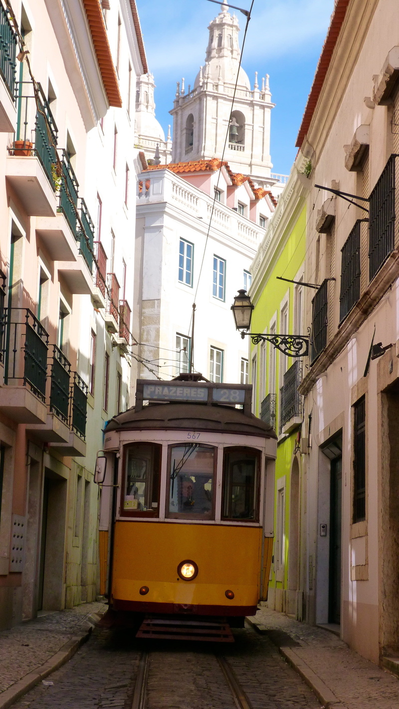 city, sunlight, means of transport, architecture, sky, day, land vehicle, track, transportation, built structure, building exterior, white, buildings, beige