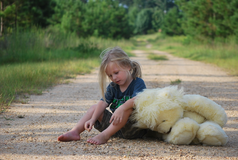 shirt, lifestyles, childhood, hairstyle, neck, black, outdoors, plush, play, nature, hair, land, kid, casual clothing, fun, toddler, happy, innocence, full length