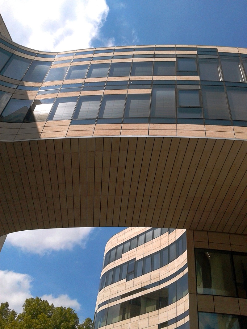 day, pattern, reflection, glass - material, no people, building, cloud - sky, facade, nature, low angle view, built structure, sunlight, mirroring, architecture