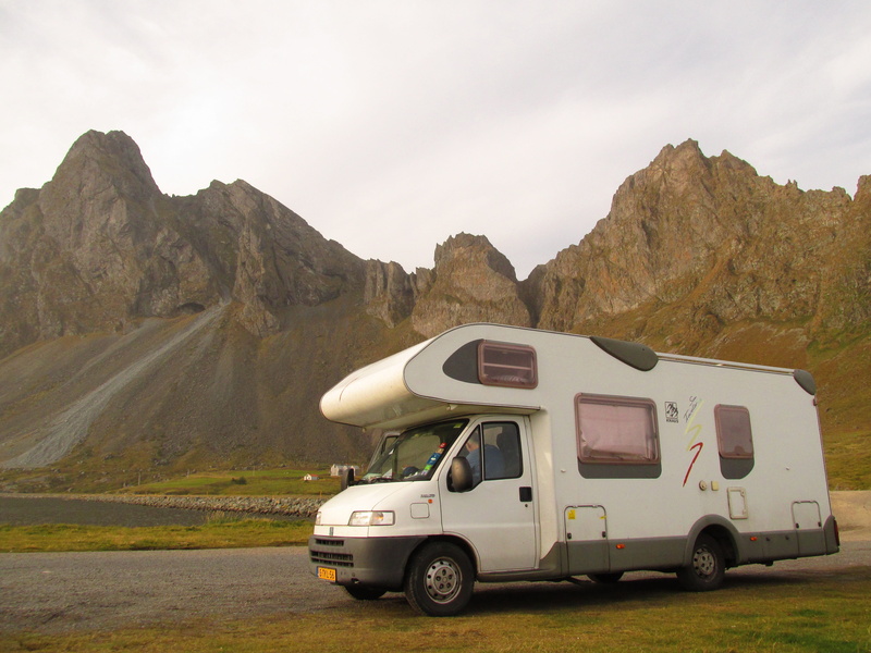 land, travel, formation, motorhome, land vehicle, campervan, stationary, transportation, beauty in nature, van - vehicle, rock, road trip, truck, environment