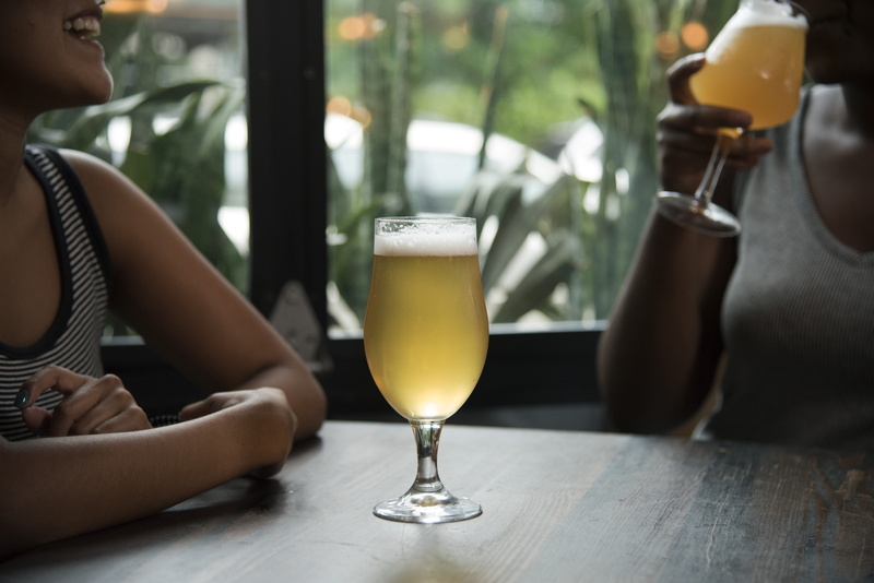 frothy drink, refreshment, real people, beverage, drinking, people, woman, transparent, pint glass, one person, bar, happy hour, adult, sitting, freshness