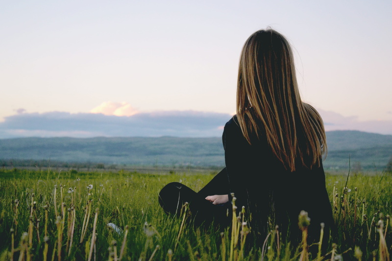 leisure activity, black, mountain, scenics - nature, cloudy, grass, beauty in nature, rural, clear sky, sitting, green, hair, woman, country, scenic, women