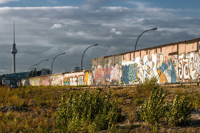 built structure, street, panorama, lighting equipment, sky, city, cloud - sky, graffiti, spire, tower, mural, plant, places of interest, wall, building