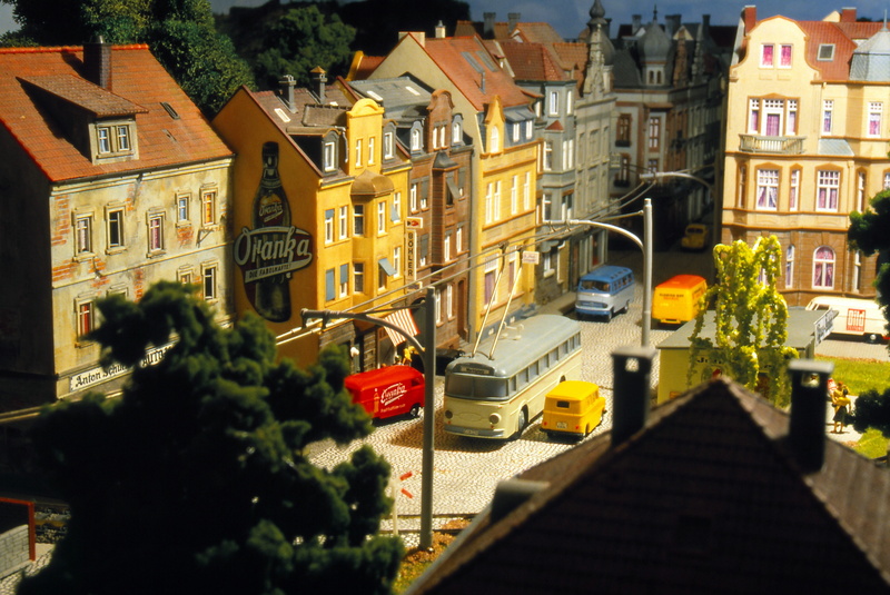 model, building exterior, city, 5K, sunlight, residential district, land vehicle, street, toys, trackless trolley, car, architecture, nature, built structure