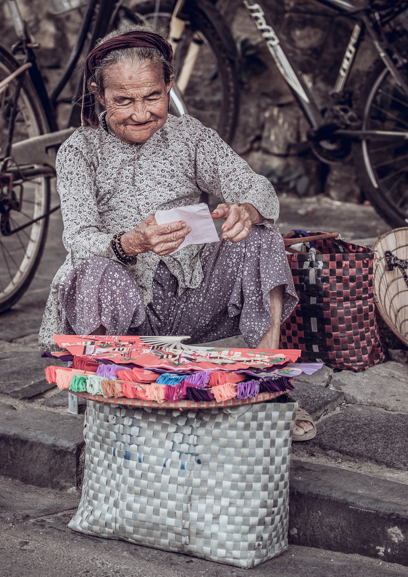 portrait, woman, street, men, concrete, sitting, smile, age, holding, fan, selling, clothing, scarf, near, fans, streetlife, grey, males, read, mature adult