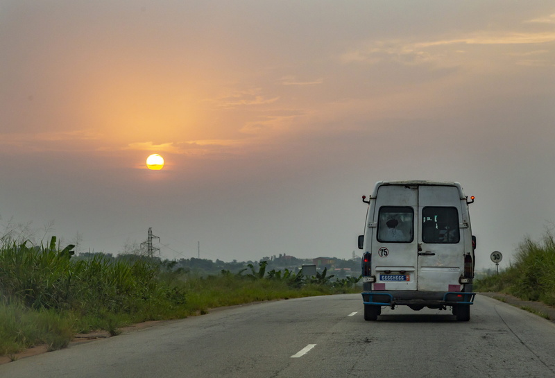 beauty in nature, cloud - sky, semi-truck, direction, sun, mode of transportation, land vehicle, sunlight, abidjan, highway, orange color, van, road, caravan