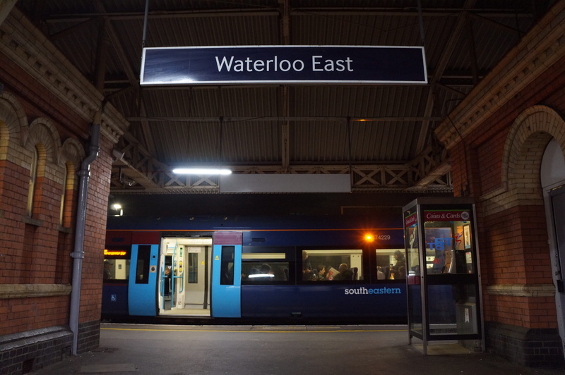 text, human, sign, mode of transportation, restaurant, door, ceiling, night, automobile, information sign, no people, train station, food, western script