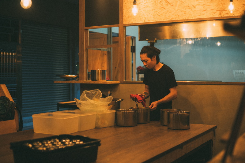 furniture, standing, waist up, food and drink, pots, pot, table, room, domestic kitchen, front, wood, three quarter length, young adult, casual clothing