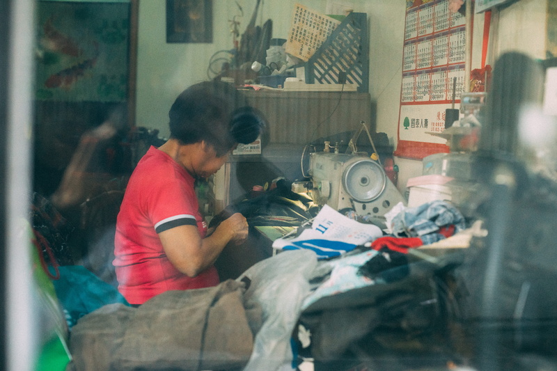 blurred motion, taiwan, sewing, furniture, bedroom, working, taichung, laundry, technology, shirt, occupation, standing, real people, three quarter length