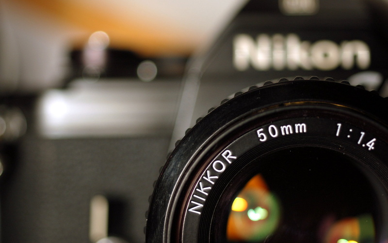 dslr, black, indoors, communication, camera, text, 1080P, modern, Other, focus on foreground, technology, actual, slr camera, black color, photographic equipment