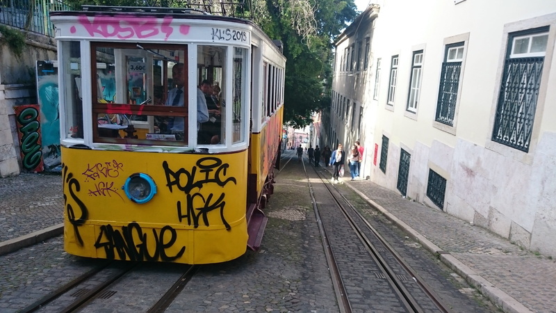 railroad track, street, electric, cable car, text, travel, rail transportation, communication, portuguese, building exterior, built structure, western script