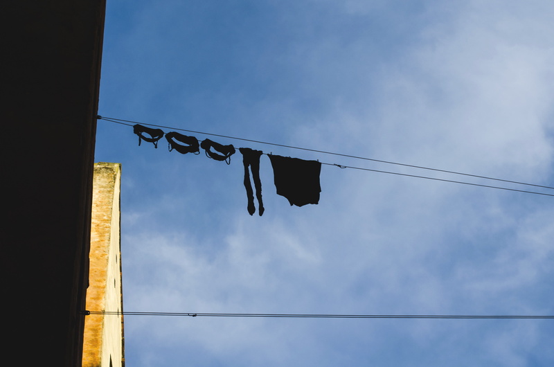 hanging, copenhagen, everyday, built structure, sun, clothesline, architecture, sunny, denmark, sky, outdoors, low angle view, electricity, cable, cloud - sky