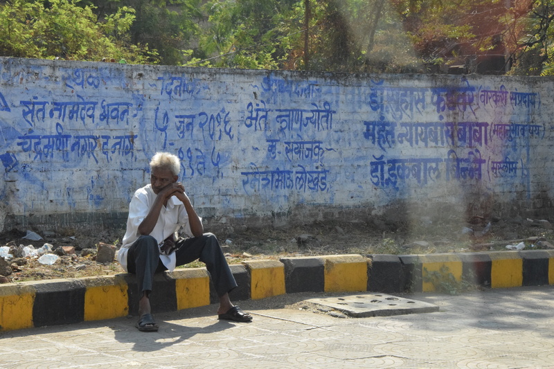 male, seat, graffiti, man, human, sunlight, lifestyles, social issues, sitting, one person, hinduism, real people, 5K, text, relaxation, leisure activity