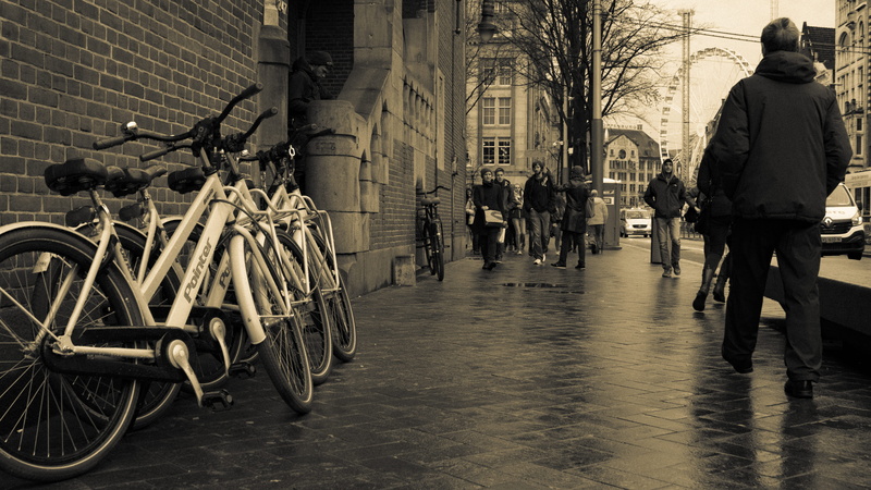 city, built structure, building exterior, land vehicle, incidental people, building, amsterdam, outdoors, ordinary, men, mode of transportation, street