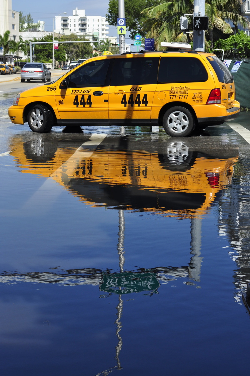 outdoors, land vehicle, car, street, day, built structure, public transportation, motion, yellow taxi, nature, no people, waterfront, motor vehicle, mode of transportation