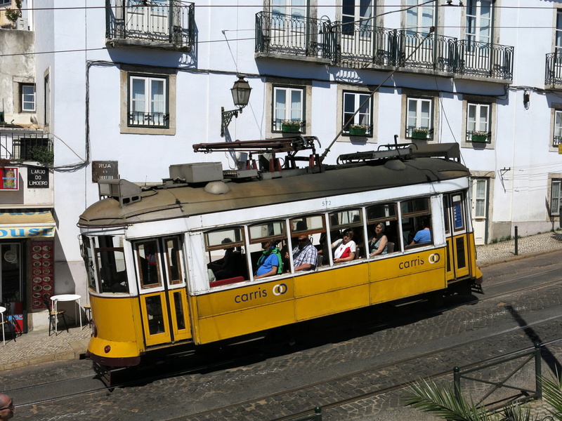 building exterior, public transport, electrically, men, outdoors, built structure, people, real people, street, carris, slowly, mode of transportation