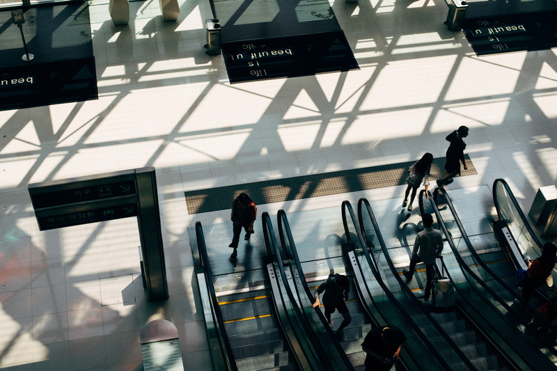 leaving, indoors, real people, escalator, journey, airport, women, high angle view, urban Scene, blurred Motion, commuter, crowd, mode of transportation