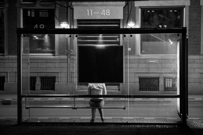 lifestyles, window, rear view, built structure, black and white, standing, architecture, evening, back, one person, public transportation, glass - material