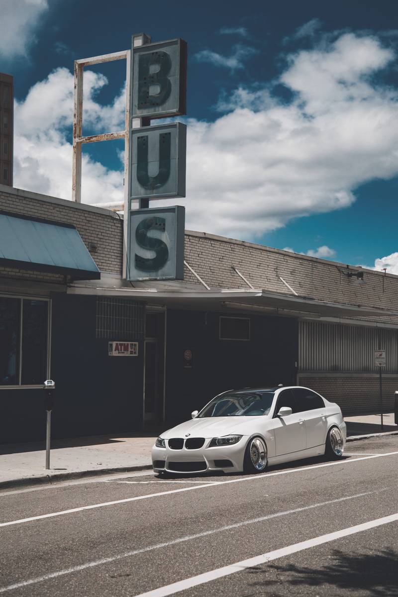 5K, white, sports car, sky, outdoors, coupe, building exterior, motor vehicle, city, asphalt, western script, food, nature, communication, car, mode of transportation
