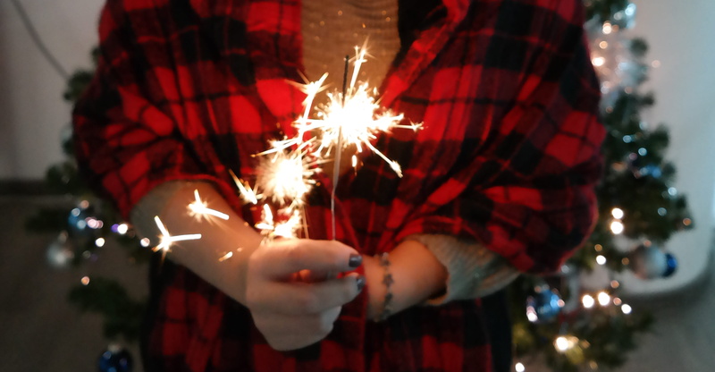 human body part, human hand, holding, female, night, illuminated, firework, burning, focus on foreground, twinkle, 2K, firework - man made object, sparkler