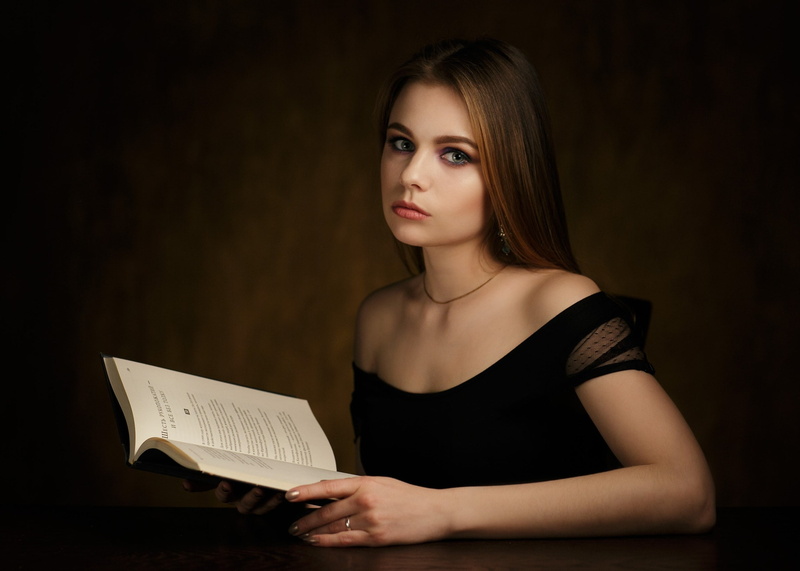 reading, holding, adult, 500px, black background, 1080P, one person, contemplation, portrait, hairstyle, looking at camera, Alex Rimsky, indoors, bare shoulders
