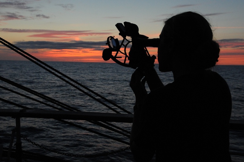 sky, ship, twilight, looking at view, beauty in nature, horizon, rear view, dusk, ocean, standing, horizon over water, orange color, vessel, water, sunset