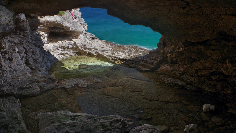  water, nature, beauty in nature, eroded, tranquility, outdoors, rock - object, day, high angle view, solid, cave, non-urban scene, rock, no people