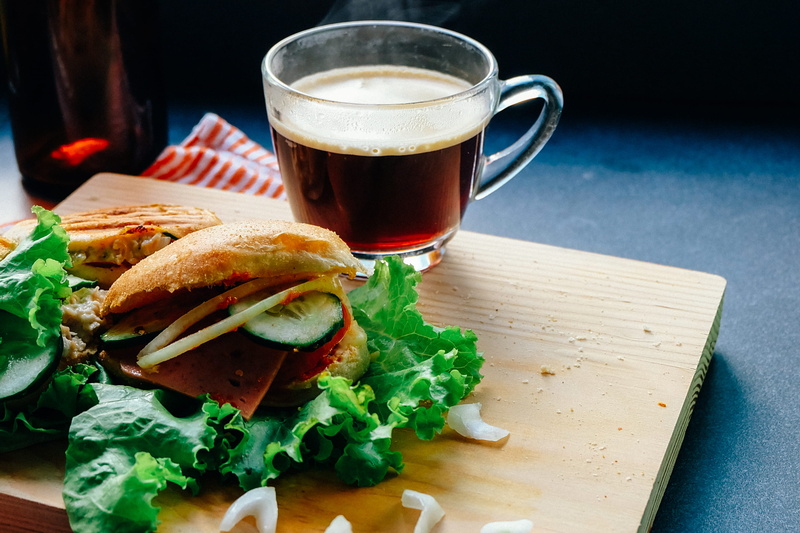 cucumber, cheeseburger, cup, hot drink, dinner, healthy eating, vegetable, table, tea cup, eating, beside, restaurant, filled, liquid, patties, meal, refreshment