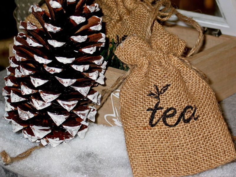 cover, tea, christmas, day, high angle view, sack, focus on foreground, clothing, indoors, hot drink, text, still life, pattern, art and craft, jute bag