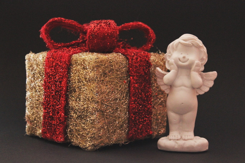 human representation, studio shot, black background, female likeness, single object, 2K, figurine, angel, male likeness, gift tape, brown, christmas time