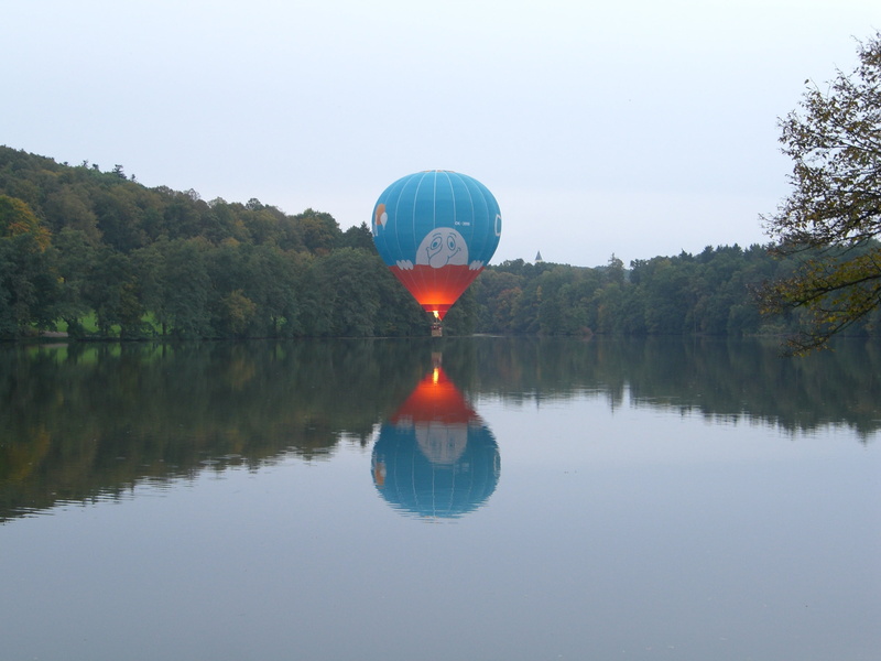 orange color, waterfront, sky, scenics - nature, plant, reflection, hot air balloon, fire, tranquil scene, hover drive, water, nature, outdoors, day, rest