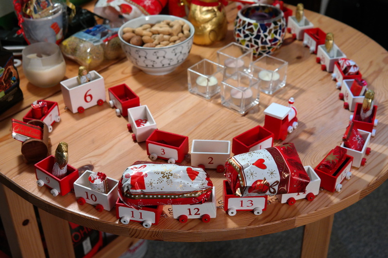no people, train, focus on foreground, wooden train, table, packed, indoors, toys, food, nicholas, surprise, wagons, christmas decoration, christmas, large group of objects