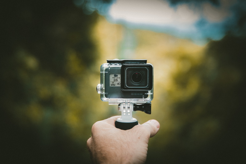 forest, selfie, hand, photographic equipment, video, green, photographer, day, holding, camera, personal perspective, human hand, equipment, focus on foreground