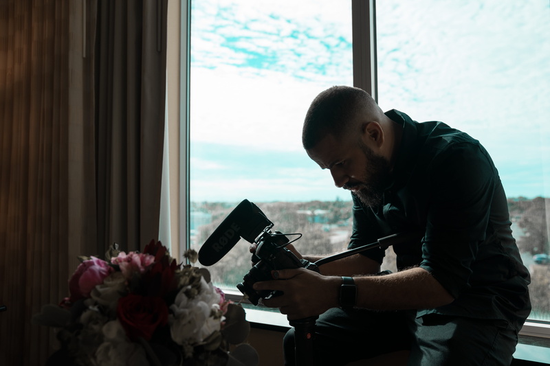 indoors, young adult, director, mid adult, flower arrangement, rode mic, one person, wedding films, young men, holding, 5K, moody, wedding video, cinematography