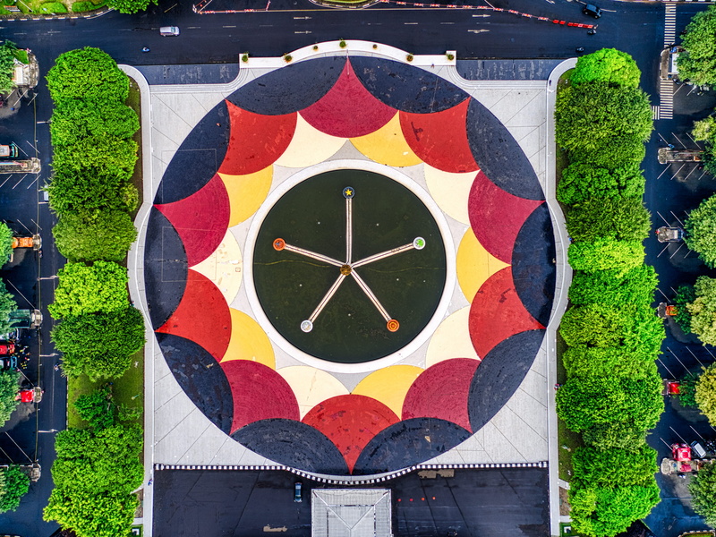 transportation system, modern, drone footage, exterior, environment, multi colored, aerial footage, close-up, aerial view, flag, roof, green, cars, nature