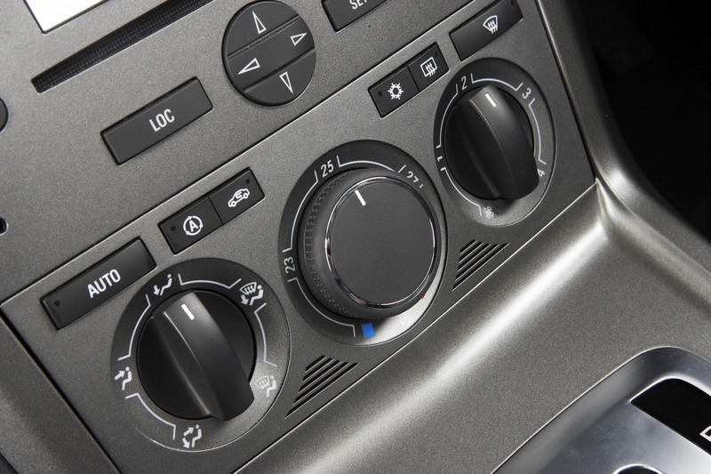 high angle view, silver colored, indoors, western script, holden, arts culture and entertainment, captiva, metal, interior, car, shape, communication, control panel