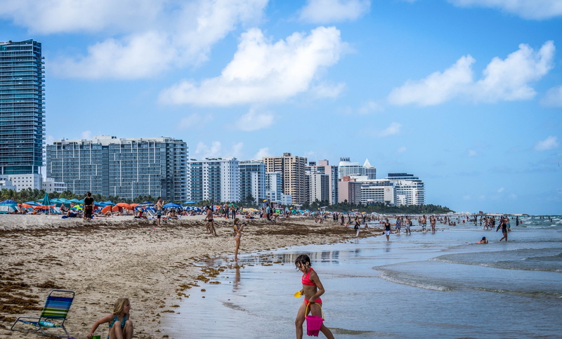 travel, leisure activity, sea, city, water, sky, building exterior, coastline, tourism, seascape, sunbathing, beach, daytime, vacations, outdoor, architecture