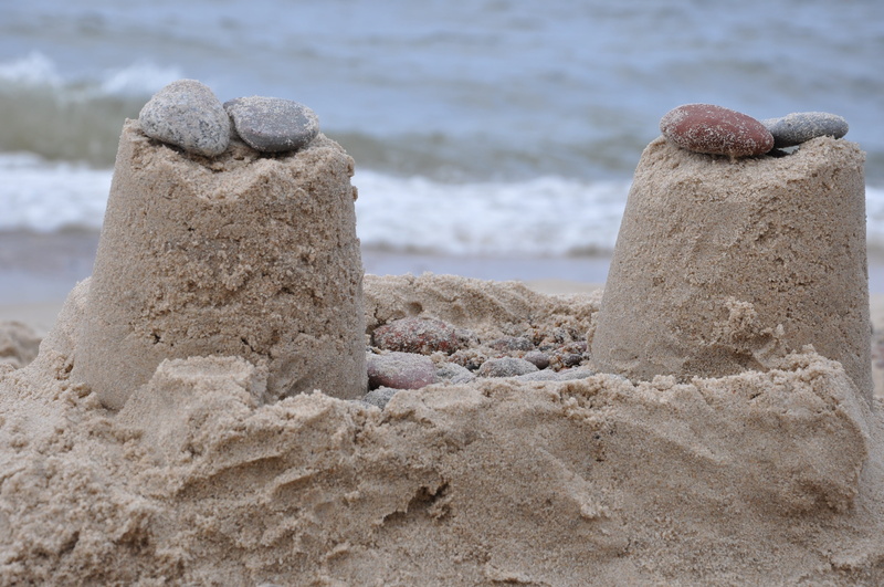 outdoors, coastline, day, sunlight, sand, beach, concrete, sea, stone, sandcastle, art and craft, creativity, rock, land, pebbles, nature, focus on foreground