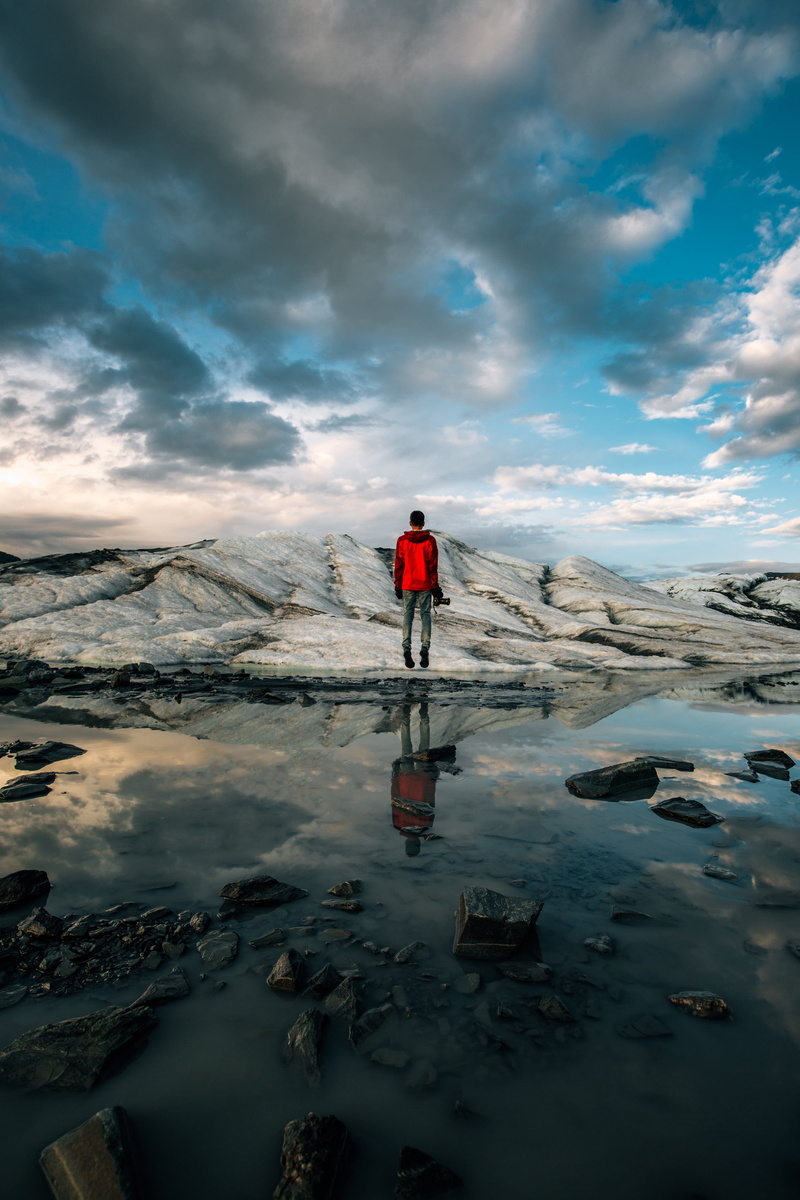 tranquility, lake, outdoors, mountain, mountain range, rocks, travel, cloudy, snow, body, puddle, sky, activity, cloud - sky, clouds, one person, leisure activity
